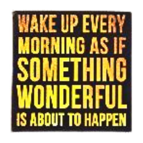 Wall art block with motivational quote in bold yellow text on a black background, reading “Wake up every morning as if something wonderful is about to happen.”